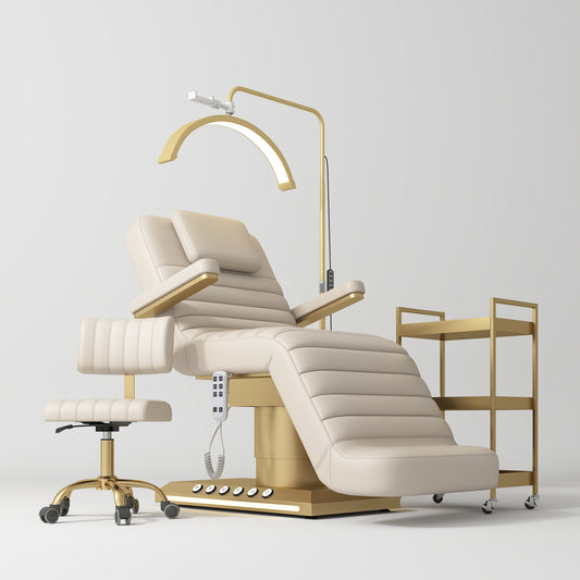 Beige and gold medical examination chair with a lamp and cart on a white background